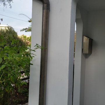 Bonderized Steel, 5 inch Half Round Seamless Gutters with Round Downspouts.