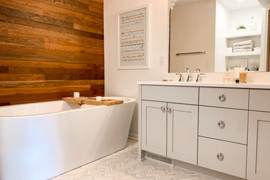 Bathroom - mid-sized transitional master white tile and ceramic tile marble floor, multicolored floor, double-sink and wood wall bathroom idea in Other with flat-panel cabinets, gray cabinets, a one-piece toilet, white walls, an undermount sink, quartz countertops, a hinged shower door, white countertops and a freestanding vanity