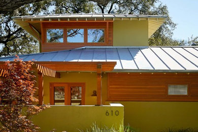Inspiration for a mid-sized contemporary stone front porch remodel in Austin with a pergola