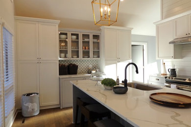 Example of a mid-sized arts and crafts u-shaped kitchen design in Raleigh with shaker cabinets, white cabinets, granite countertops, stainless steel appliances and an island