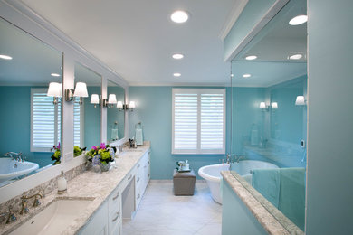 Large elegant master white tile and stone tile porcelain tile freestanding bathtub photo in Wichita with recessed-panel cabinets, white cabinets, blue walls, an undermount sink and quartz countertops