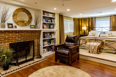 Bedroom - mid-sized traditional master medium tone wood floor and brown floor bedroom idea in Other with beige walls, a standard fireplace and a brick fireplace