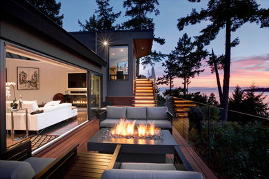 Inspiration for a mid-sized rustic side yard deck remodel in Vancouver with a fireplace and no cover