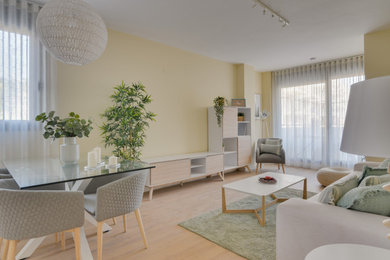 Living room - mid-sized scandinavian enclosed laminate floor and brown floor living room idea in Seville with beige walls and no fireplace