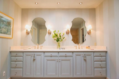 Design ideas for a large traditional master bathroom in Phoenix with beaded inset cabinets, blue cabinets, beige walls, an undermount sink and solid surface benchtops.