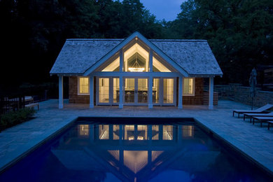 Mid-sized beach style backyard tile and rectangular hot tub photo in New York