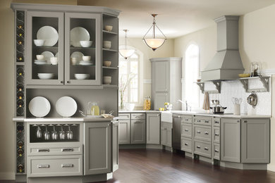 Enclosed kitchen - large traditional u-shaped dark wood floor and brown floor enclosed kitchen idea in New York with a farmhouse sink, recessed-panel cabinets, gray cabinets, window backsplash, stainless steel appliances and no island
