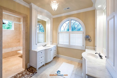 Doorless shower - huge craftsman master white tile ceramic tile doorless shower idea in Portland with an undermount sink, furniture-like cabinets, white cabinets, granite countertops and beige walls