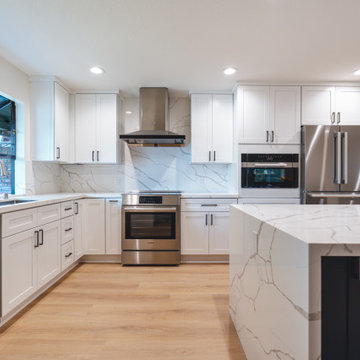Modern White Shaker Kitchen with Navy Blue Island and Waterfall Quartz Counterto