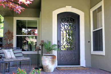 Example of a large tuscan green two-story stucco exterior home design in San Francisco