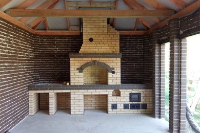 Photo of a medium sized farmhouse courtyard patio in Other with an outdoor kitchen, brick paving and a gazebo.