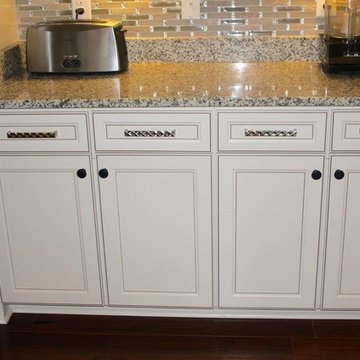 Oversized brushed nickel pulls are combined with black knobs