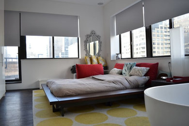 Example of a large trendy master dark wood floor bedroom design in New York with white walls and no fireplace