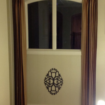 Tall luscious long panels enhance with a small bronze rod