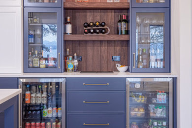 Example of an arts and crafts home bar design in Charlotte