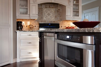 Open concept kitchen - large victorian l-shaped open concept kitchen idea in Toronto with an undermount sink, raised-panel cabinets, white cabinets, granite countertops, beige backsplash, ceramic backsplash, stainless steel appliances and an island