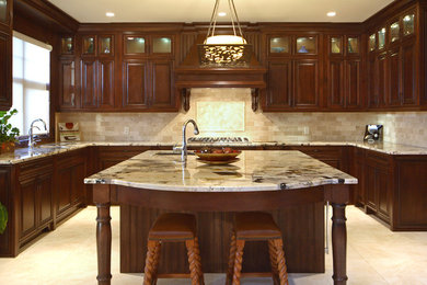 Example of a classic kitchen design in Calgary with raised-panel cabinets and dark wood cabinets