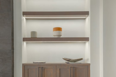 Example of a minimalist kitchen design in Albuquerque with flat-panel cabinets, gray cabinets, quartzite countertops, an island and white countertops