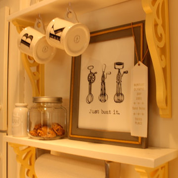 A wall without upper cabinets becomes functional with open shelves.