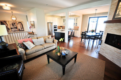 Example of a small trendy open concept dark wood floor living room design in Other with gray walls, a corner fireplace, a stone fireplace and a media wall