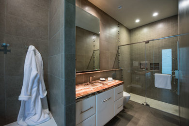 Inspiration for a contemporary bathroom in Houston with an integrated sink, flat-panel cabinets, white cabinets, a double shower and gray tile.
