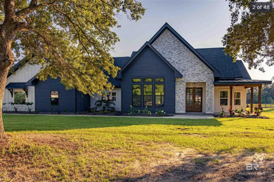 Inspiration for a mid-sized french country mixed siding exterior home remodel in Other with a shingle roof and a black roof