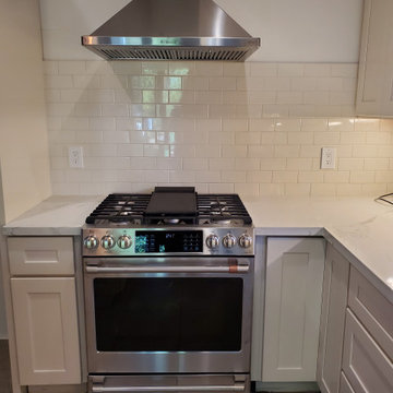 open concept kitchen with island and subway back splash