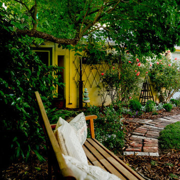 Shaded Garden Path with Bench and Layered Plantings