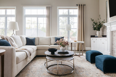 Example of a large classic formal and open concept dark wood floor, brown floor and vaulted ceiling living room design in Chicago with beige walls, a standard fireplace, a stone fireplace and a wall-mounted tv