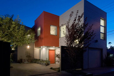 Inspiration for a modern two-story concrete fiberboard flat roof remodel in Other