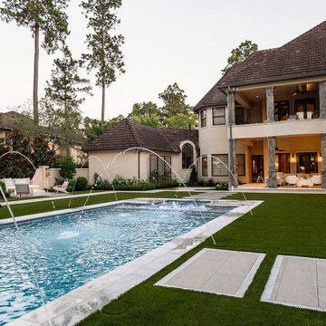 Rectangular pool, covered patio and kitchen, outdoor shower, landscaping