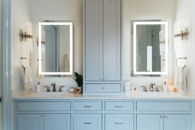 Inspiration for a master white tile and marble tile porcelain tile, blue floor and double-sink bathroom remodel in Austin with shaker cabinets, blue cabinets, a two-piece toilet, white walls, an undermount sink, quartz countertops, a hinged shower door, white countertops and a built-in vanity