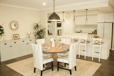 Inspiration for a mid-sized beach style kitchen/dining combo in Perth with beige walls and ceramic floors.