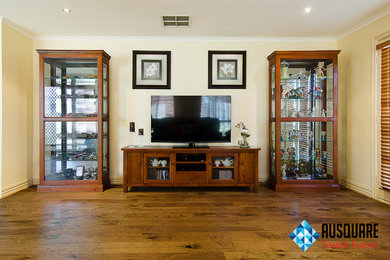 This is an example of a mid-sized country open concept family room in Melbourne with light hardwood floors.