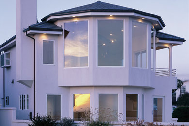Large transitional white two-story house exterior idea in Denver