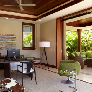 Large tropical study room in Hawaii with beige walls, a freestanding desk, slate floors and beige floor.