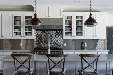 Kitchen - large transitional medium tone wood floor kitchen idea in Dallas with a farmhouse sink, shaker cabinets, white cabinets, marble countertops, metallic backsplash, metal backsplash, stainless steel appliances and an island