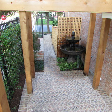 High function in a small side yard! Pergola, raised bed, mirrored wall, fountain