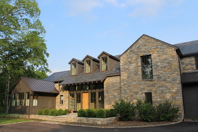 Inspiration for a large transitional two-story stone house exterior remodel in Nashville