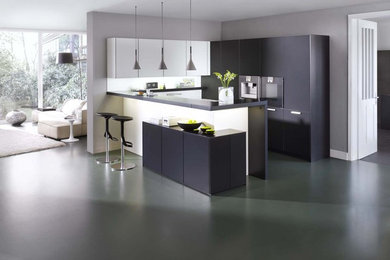 Photo of a modern l-shaped kitchen in Stuttgart with flat-panel cabinets.