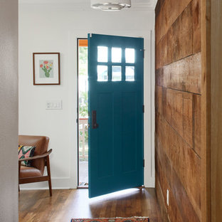 Idéer för mellanstora eklektiska ingångspartier, med vita väggar, mellanmörkt trägolv, en enkeldörr, en blå dörr och brunt golv