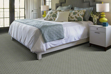 Photo of a mid-sized contemporary master bedroom in New York with beige walls and carpet.
