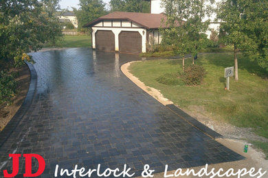 Example of a large minimalist front yard concrete paver patio design in Other