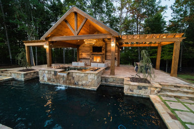 Large traditional backyard pool in Atlanta with a pool house.