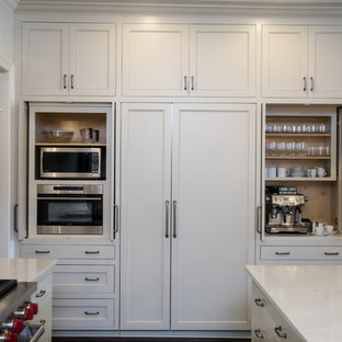Transitional kitchen pantry ideas - Kitchen pantry - transitional l-shaped kitchen pantry idea in New Orleans with a single-bowl sink, shaker cabinets, white cabinets, quartz countertops, white backsplash, stainless steel appliances, an island and white countertops