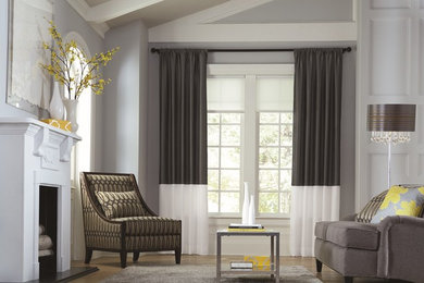 Mid-sized trendy formal and enclosed light wood floor living room photo in Calgary with gray walls, a standard fireplace, a plaster fireplace and no tv
