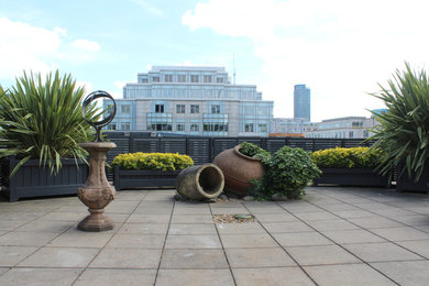 Design ideas for a large contemporary rooftop deck in London with a container garden.