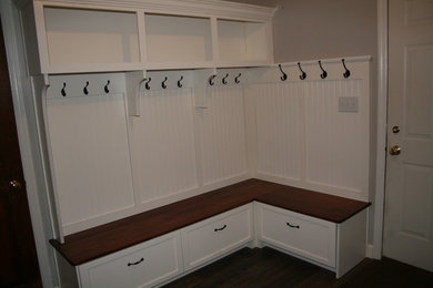 This is an example of a mid-sized contemporary l-shaped utility room in Other with beaded inset cabinets and white cabinets.