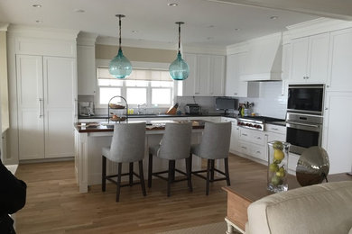 Example of a mid-sized beach style l-shaped open concept kitchen design in Other with shaker cabinets, white cabinets and an island