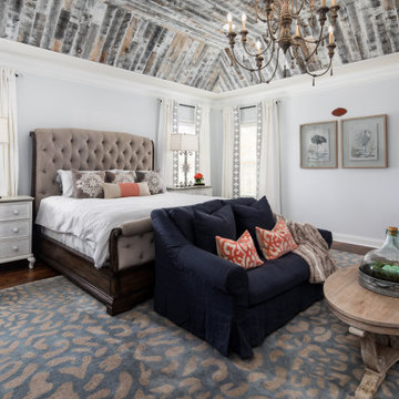 Wood Tray Ceiling with Pops of Coral Master Suite